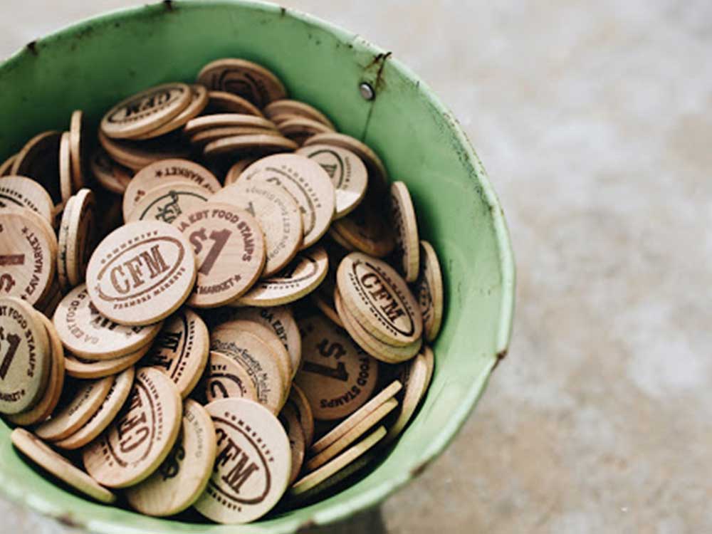An image of the physical, wooden tokens ($1 increments) that the current EBT system uses.