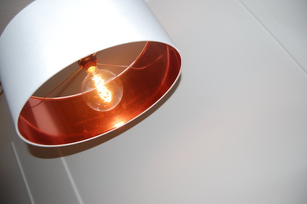 White lampshade with copper lining interior