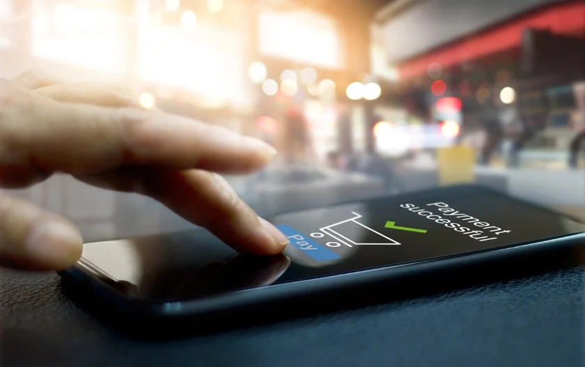 hand-touching-mobile-screen-of-a-payment-successful-message-on-mall-picture-id896567288.jpg