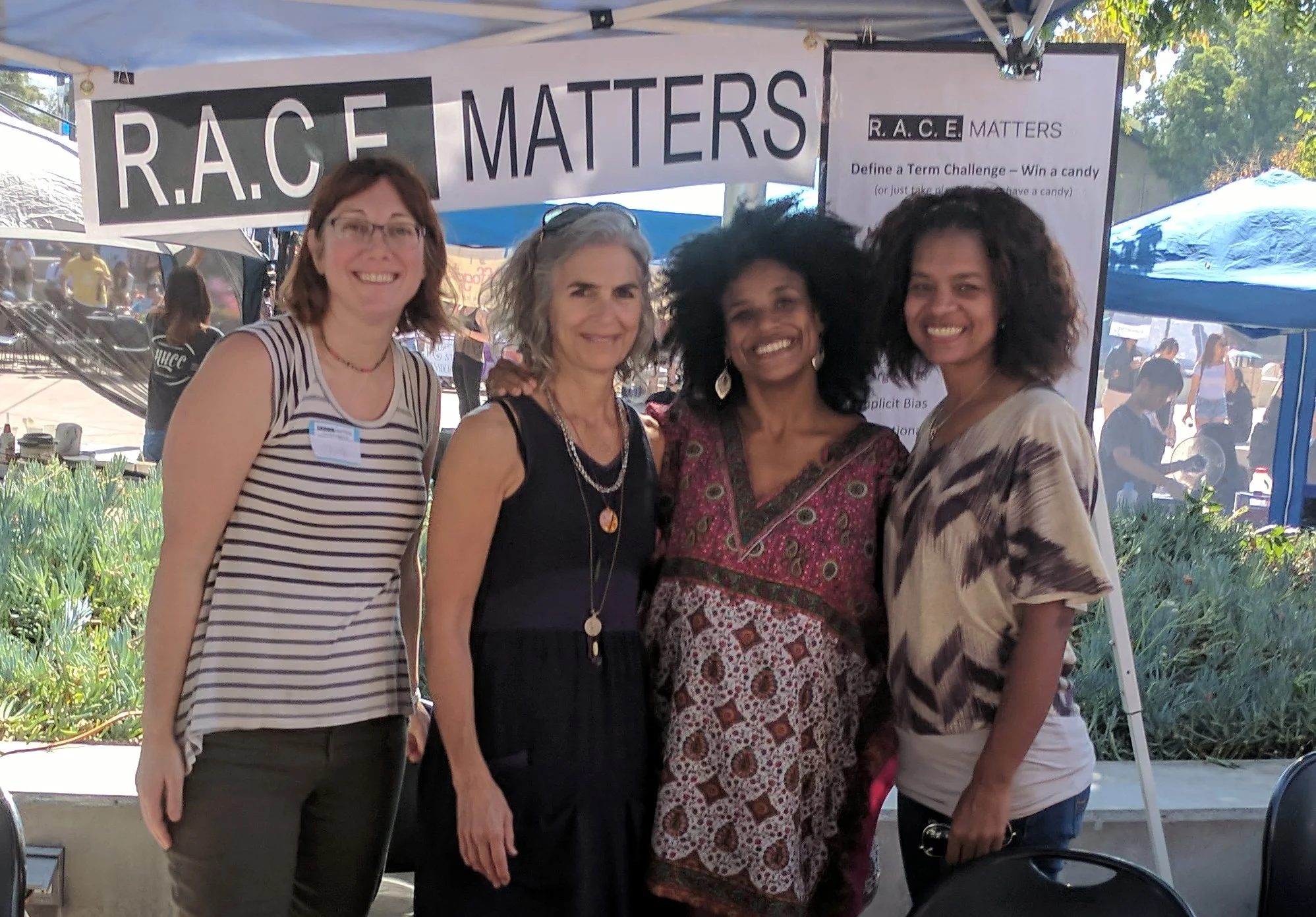 Julie Fallon, Stephanie Allen, Courtney Haile, and Julie Lynem woman a booth at Cal Poly's Culture Fest.