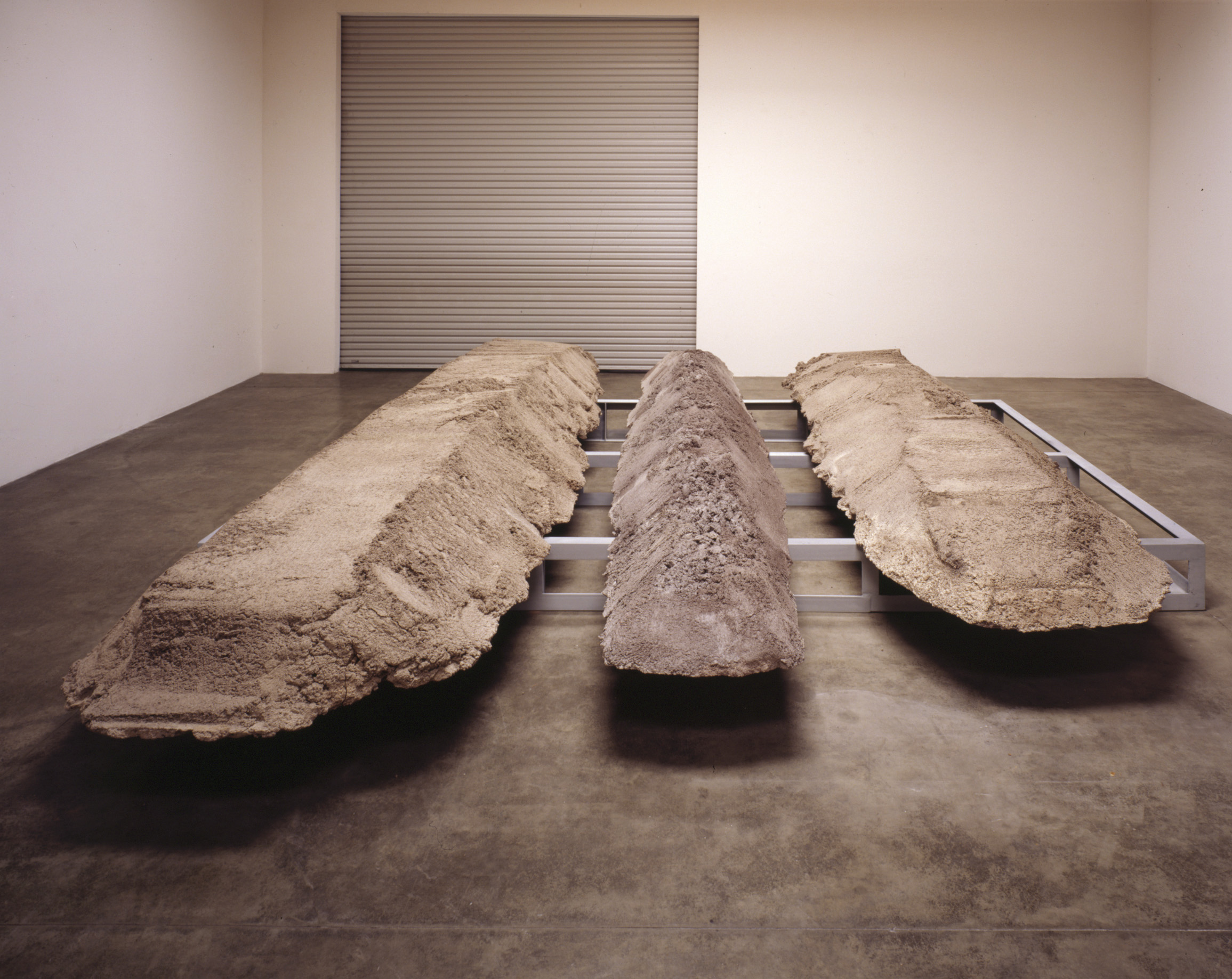 Michael Heiser Massive Celt Offering 1989 Fred Hoffman Gallery 1990 .jpg