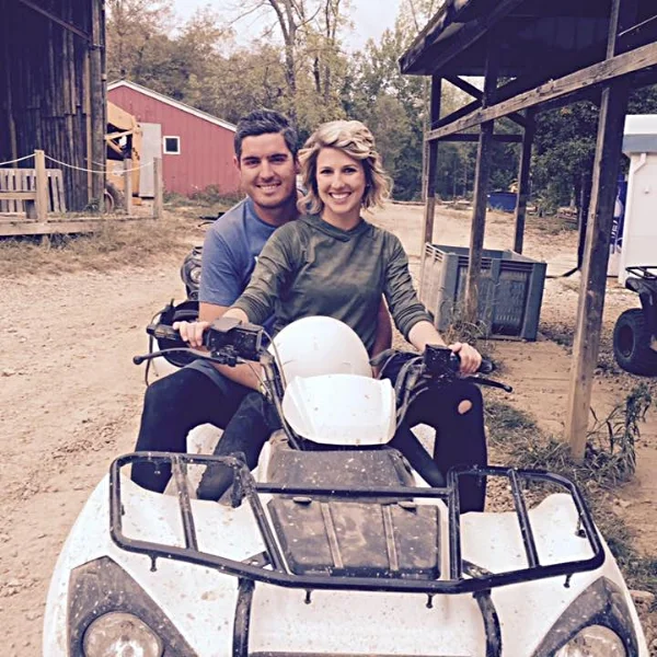 Ivanoff and wife sitting on four wheeler, the head of Columbus landscaping company.