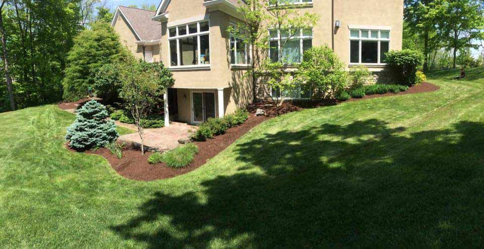 Beautiful landscaped back yard of home, lawn care by landscape company.