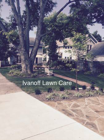 Residential front yard near driveway by local lawn care and landscape company.