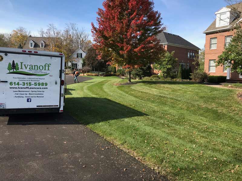 Trailer of Ivanoff Lawn Care and Landscaping near recently mowed lawn.