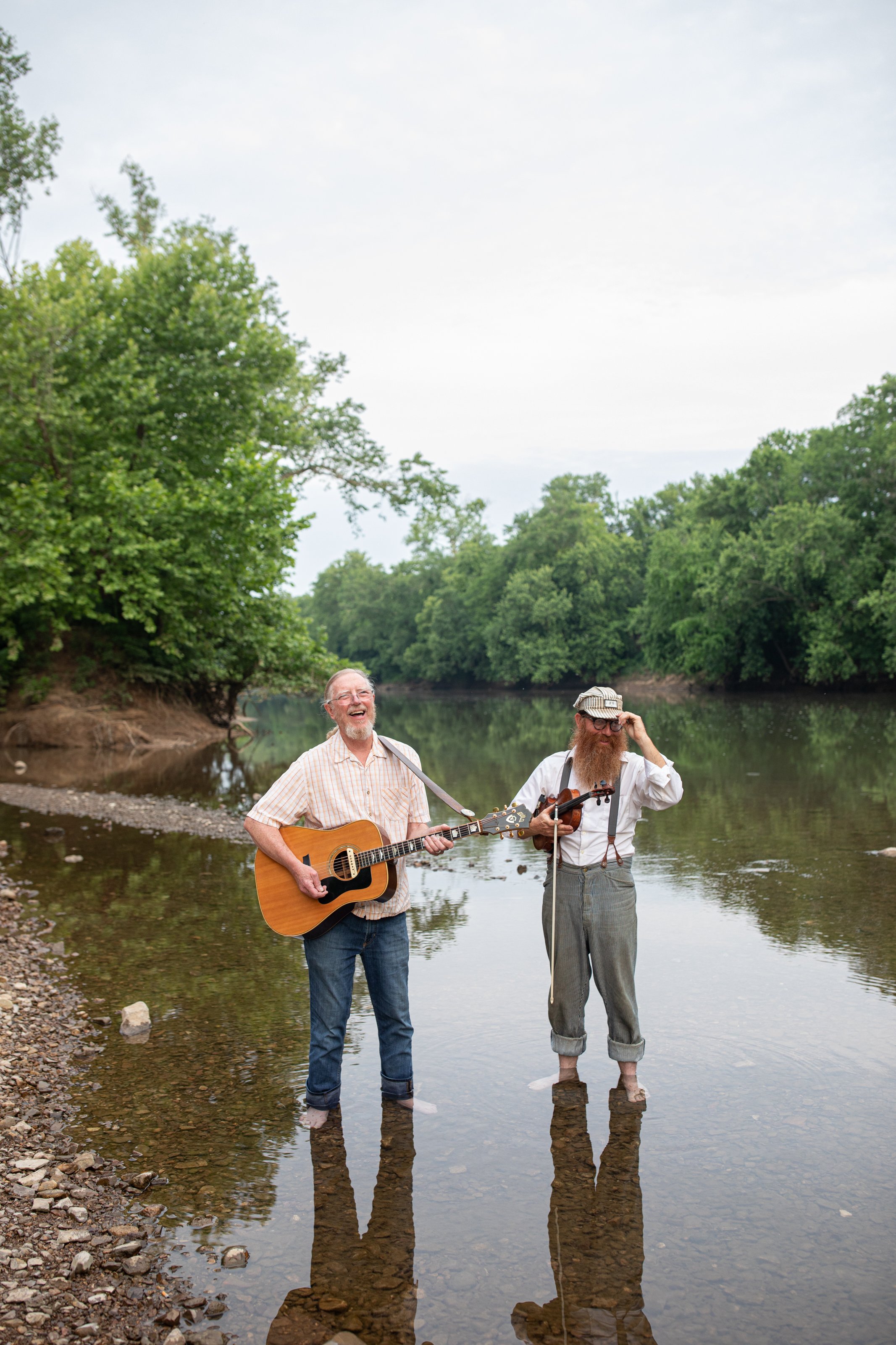 Maury County Residents Gary Grau and Daniel Foulks play a tune while standing in the Duck River Photo by Sarah B Gilliam.jpg
