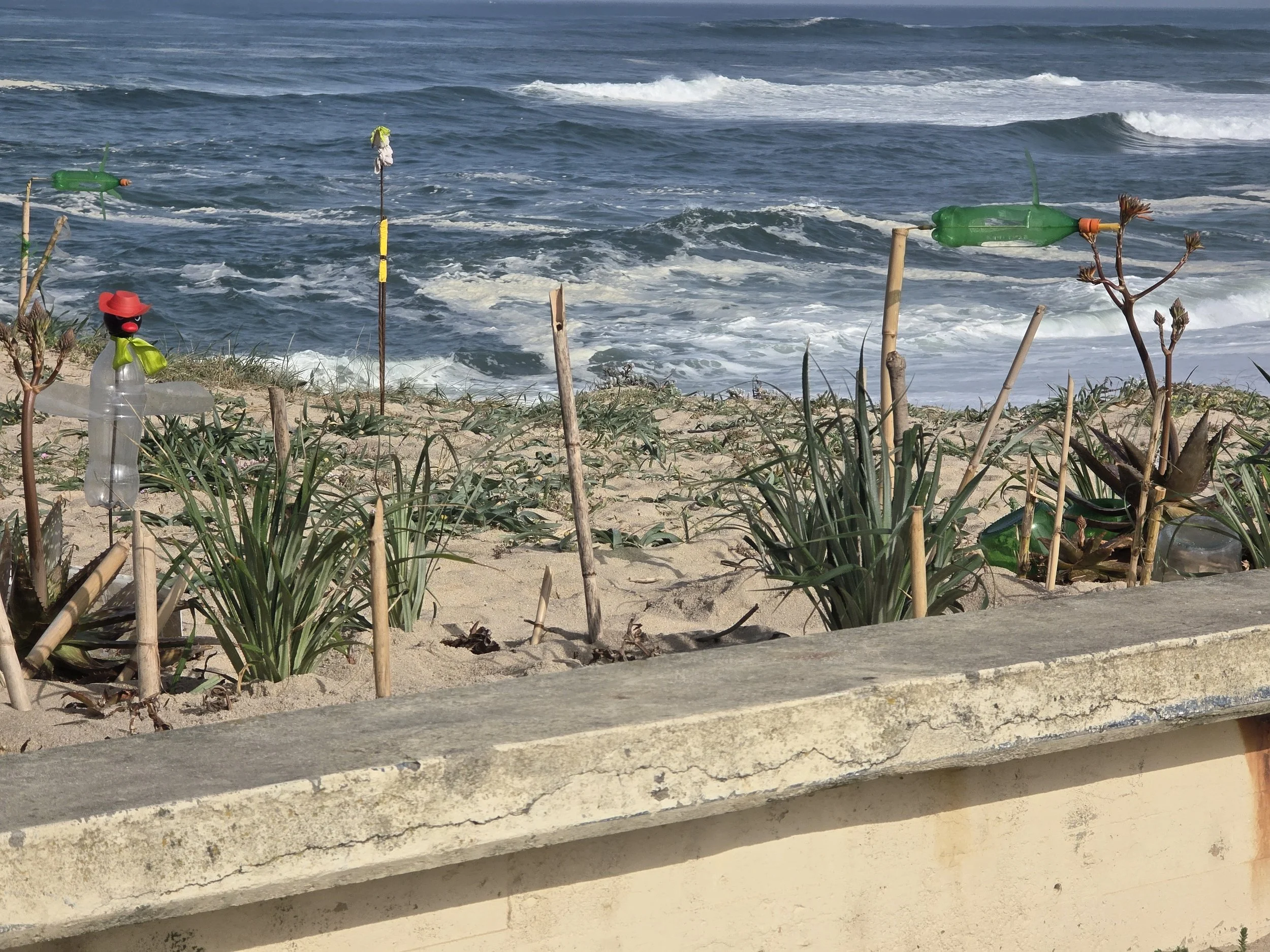 Beach folk art: You can see a  pilgrim bottle and wind spinners
