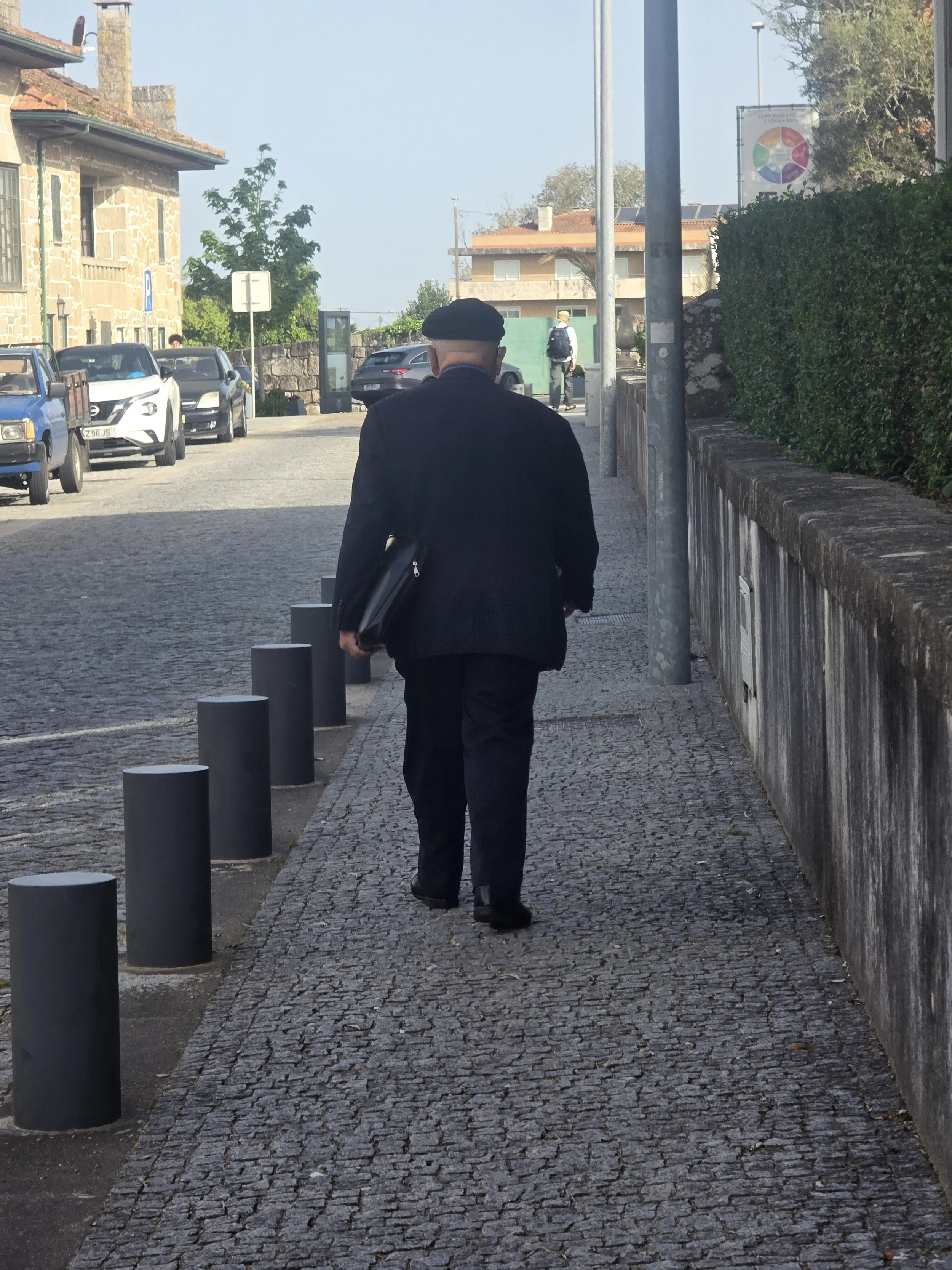 Early in the morning on our way out, we met this man. As he walked he picked up the trash. I think he was going to the church but I am not sure.