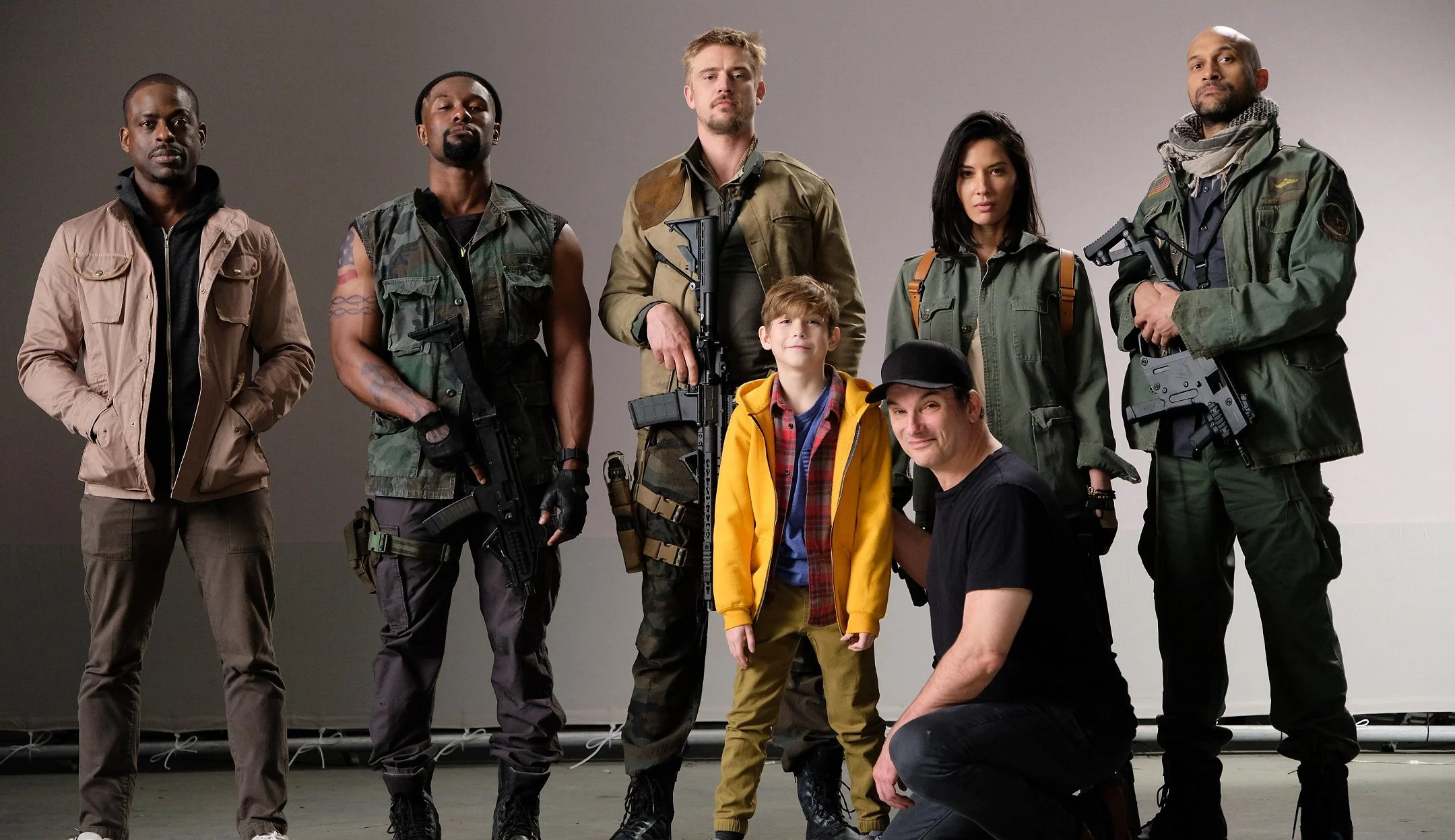 Sidebar-1-photo-The-cast-back-row-from-left-Sterling-K.-Brown-Trevante-Rhodes-Boyd-Holbrook-Olivia-Munn-Keegan-Michael-Key-front-row-Jacob-Tremblay-and-director-Shane-Black-1.jpg