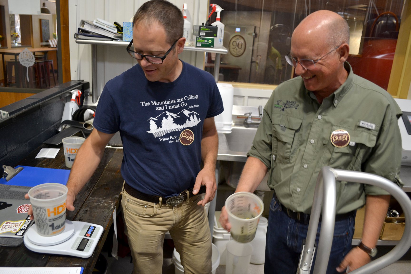 U.S. Forest Service Fisheries Biologist Matt Fairchild and Rocky Mountain Flycasters President Mickey McGuire measure up a small amount of hops to give the pilsner the lightest touch of bitterness. Other ingredients will evoke essences of a high alpine stream.