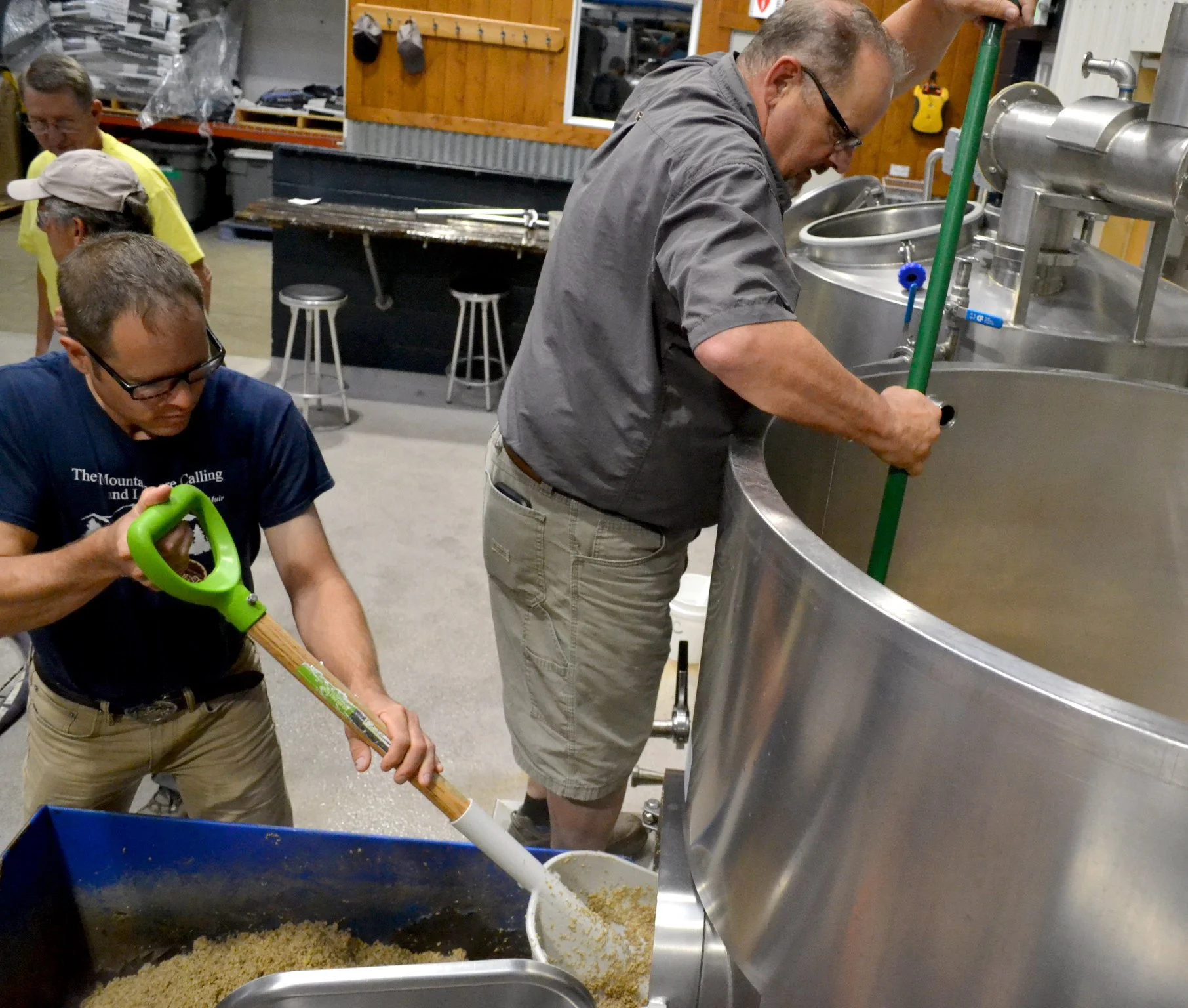 Shoveling: USFS Matt Fairchild and CTU board member/Flycasters member Dick Jefferies help shovel spent barley into a cart. It will later become feed for local cattle.