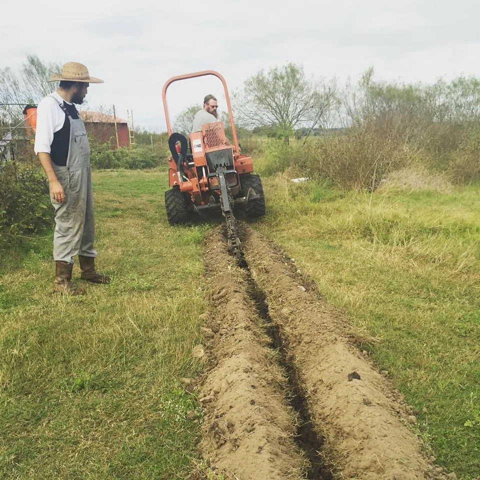 Boxcar Farm & Garden: Digging trenches to carry water to pastured pigs.