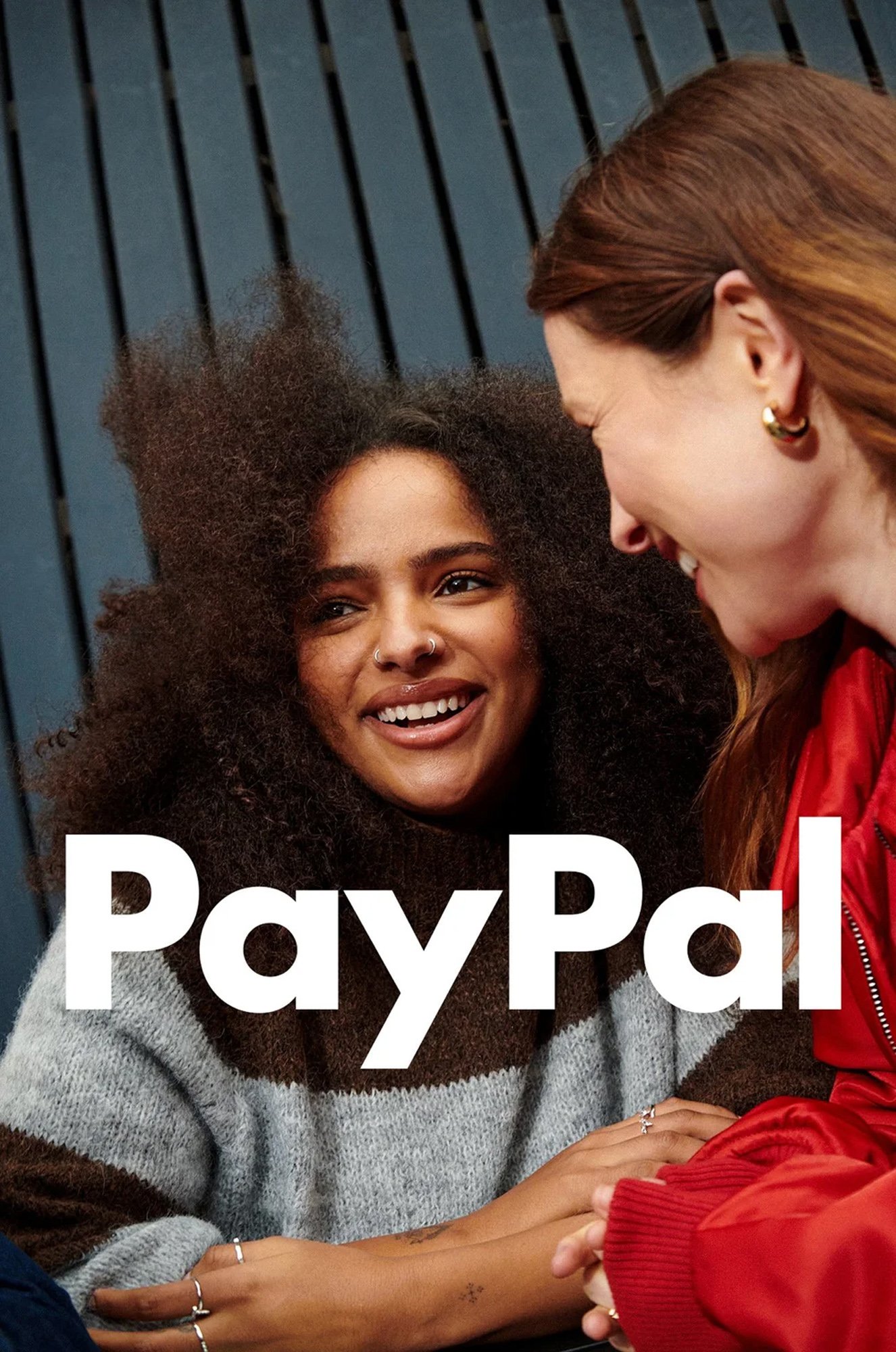 Two women smiling and talking, with the PayPal logo overlayed at the bottom.