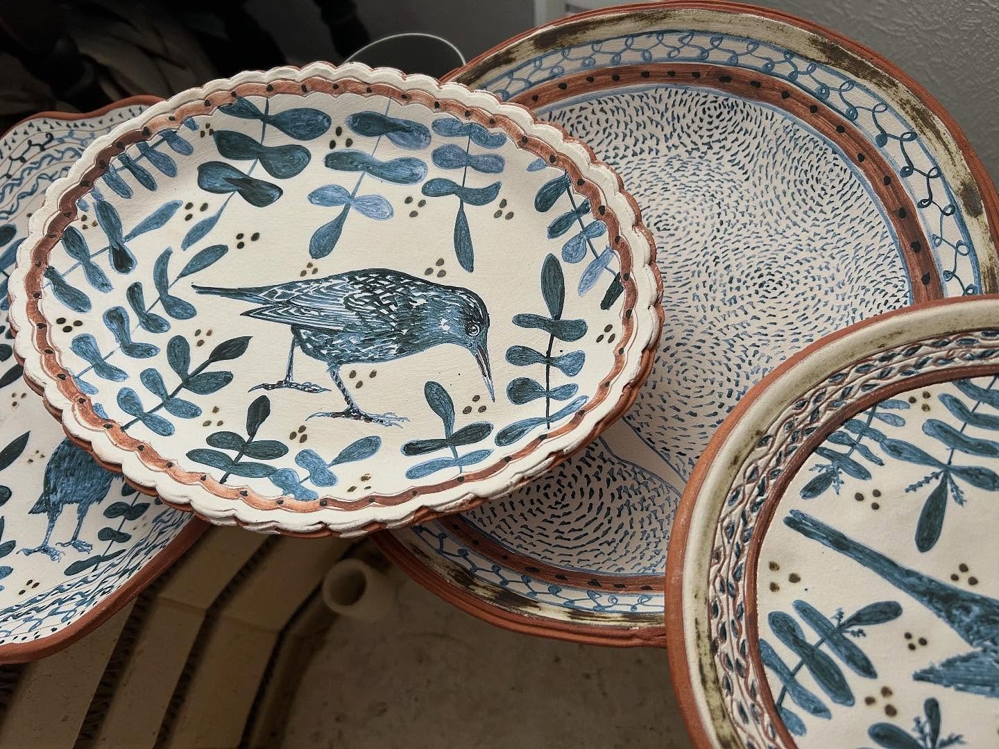 Now bisque fired and ready for glazing… back to back firing right now… #plate #platter #bowl #handmade #handpainted #inspiredbynature #inspiredbybirds #slipware #slipwarepottery #illustratedceramics #starling