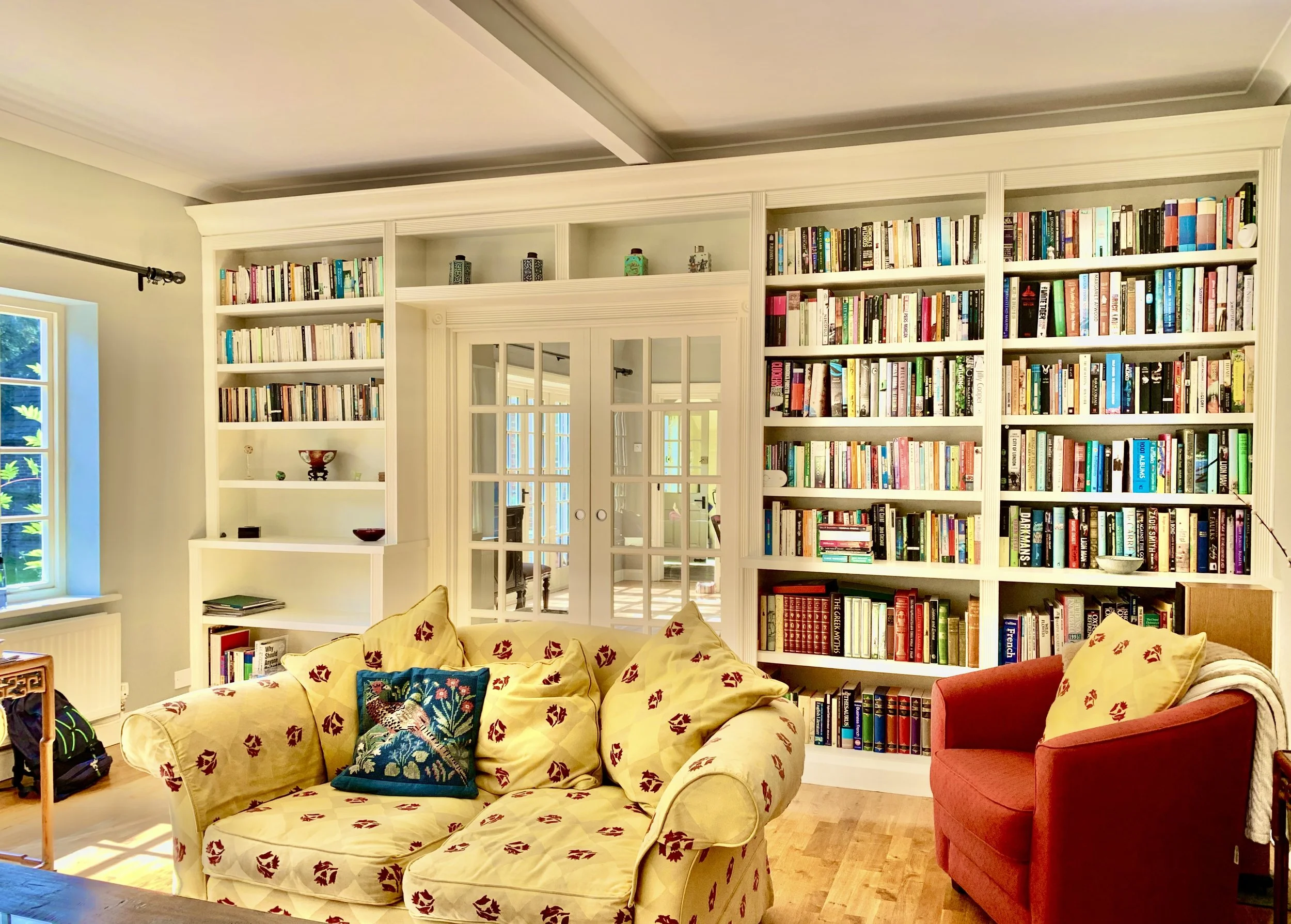 library-wall-double-pocket-doors-thick-shelves-hand-painted.jpg