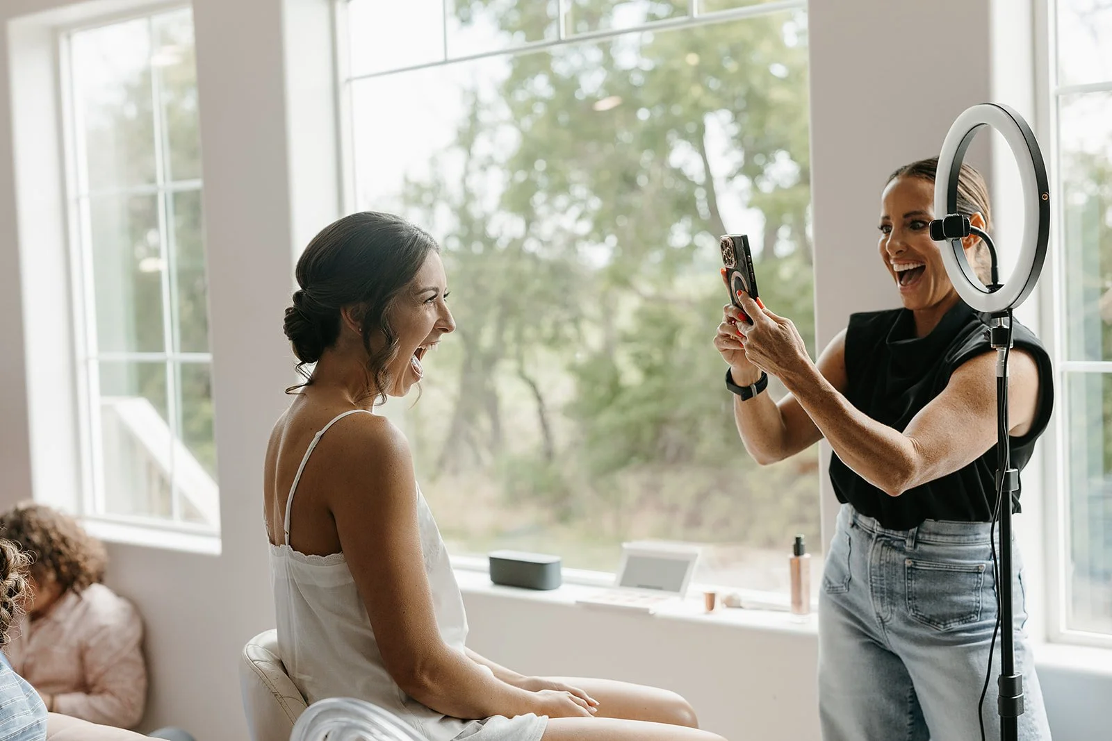 the joy on a bride's face seeing herself in the mirror after makeup is done