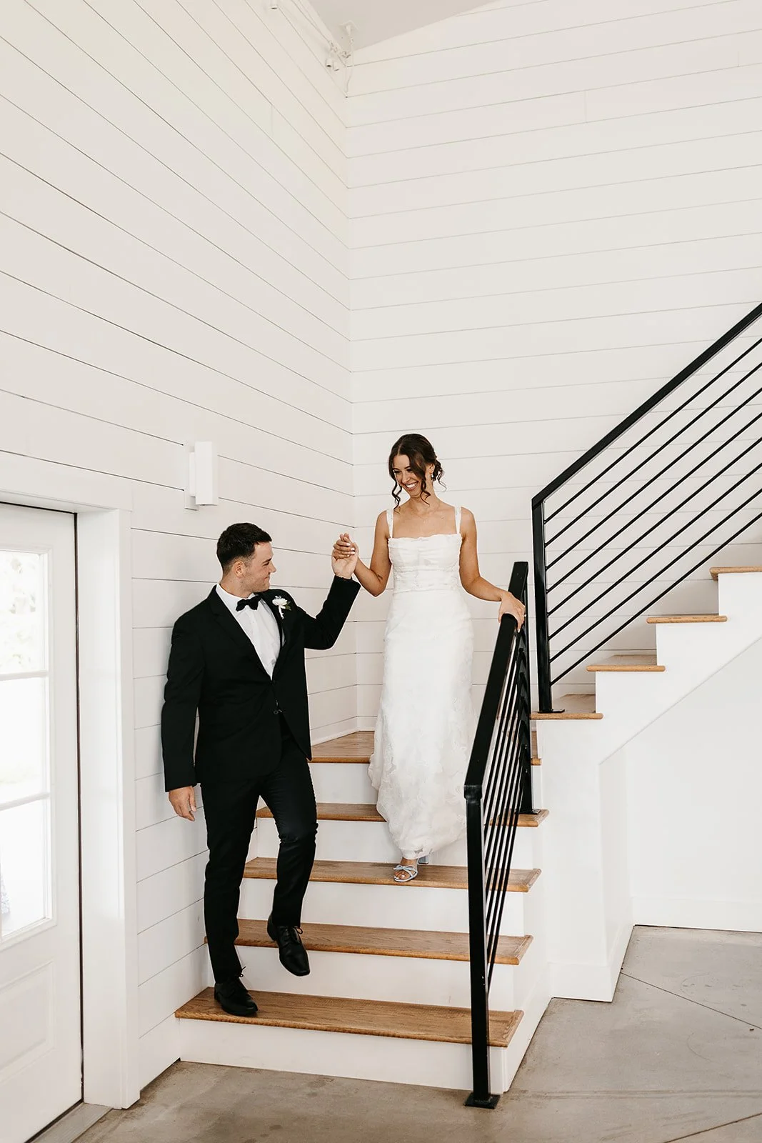 bride and groom coming down the staircase at The Barn at Grace Hill