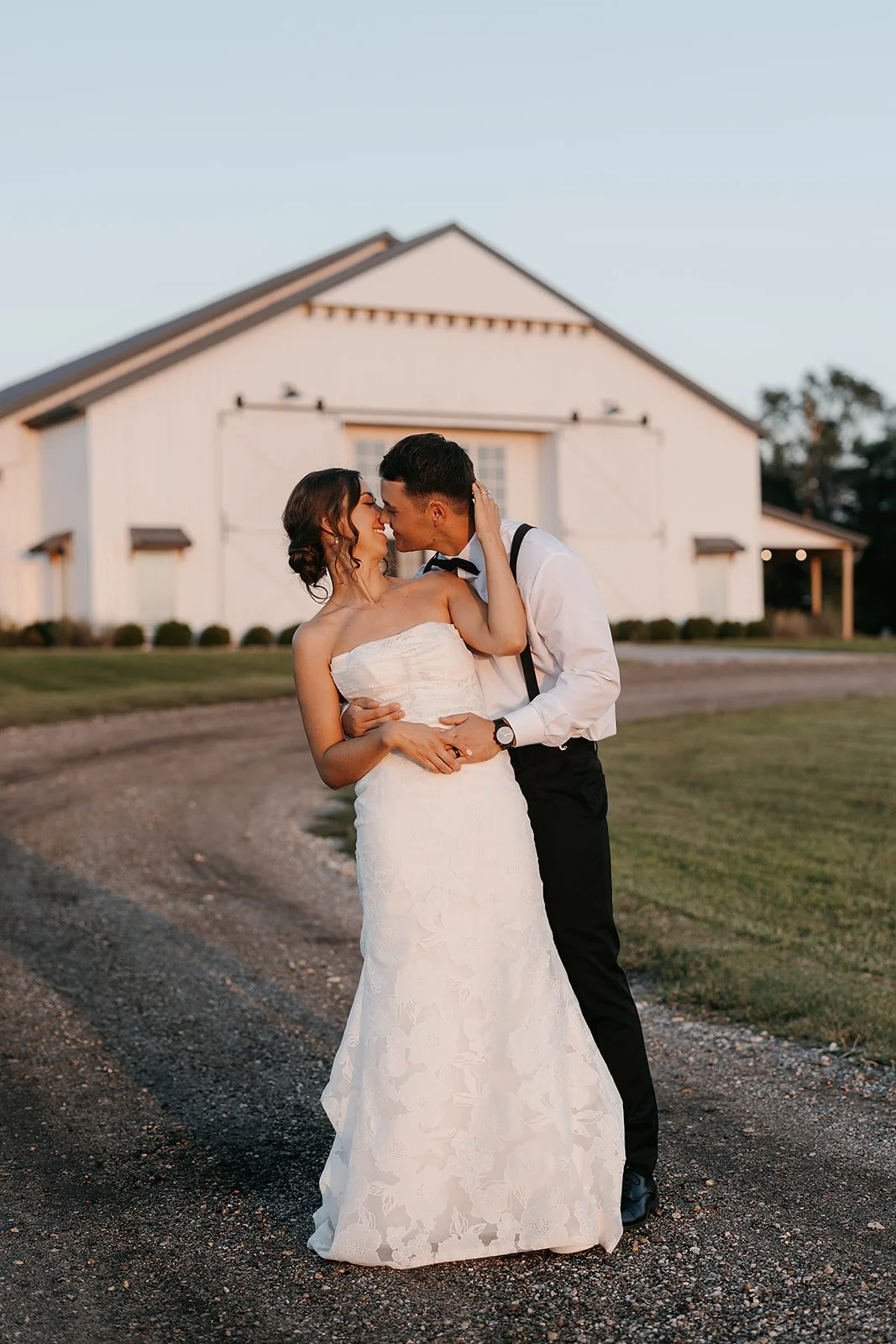 bride and groom in front of dream wedding venue near wichita kansas