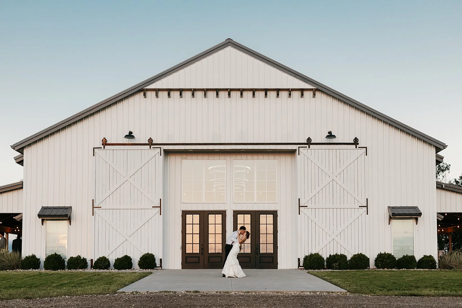 bride and groom in front of The Barn at Grace Hill