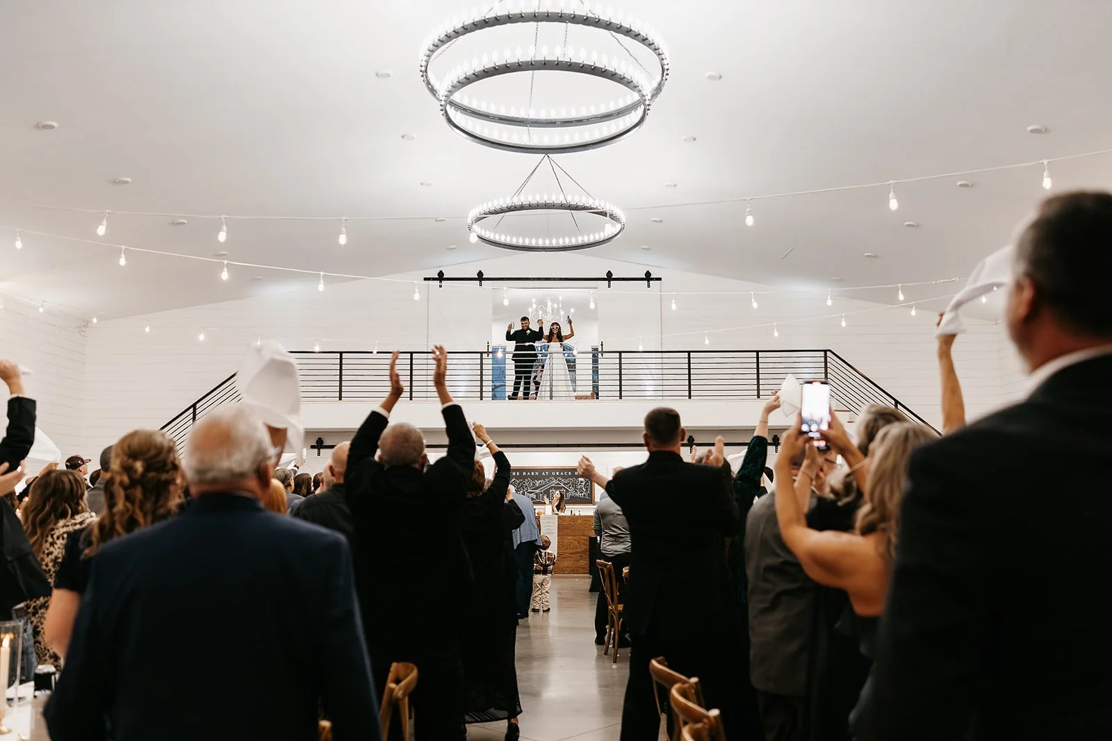 bride and groom grand introduction at their wedding reception from the balcony