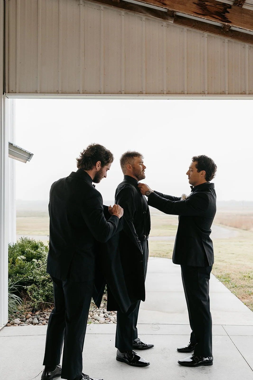 groom on the patio getting ready for his first look