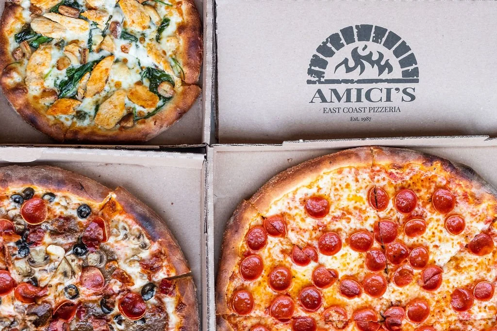 Three New York-style pizzas delivered by Amici’s.