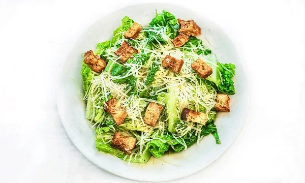 Amici’s Caesar Salad with crisp romaine, croutons, grated parmesan, served with Caesar dressing.