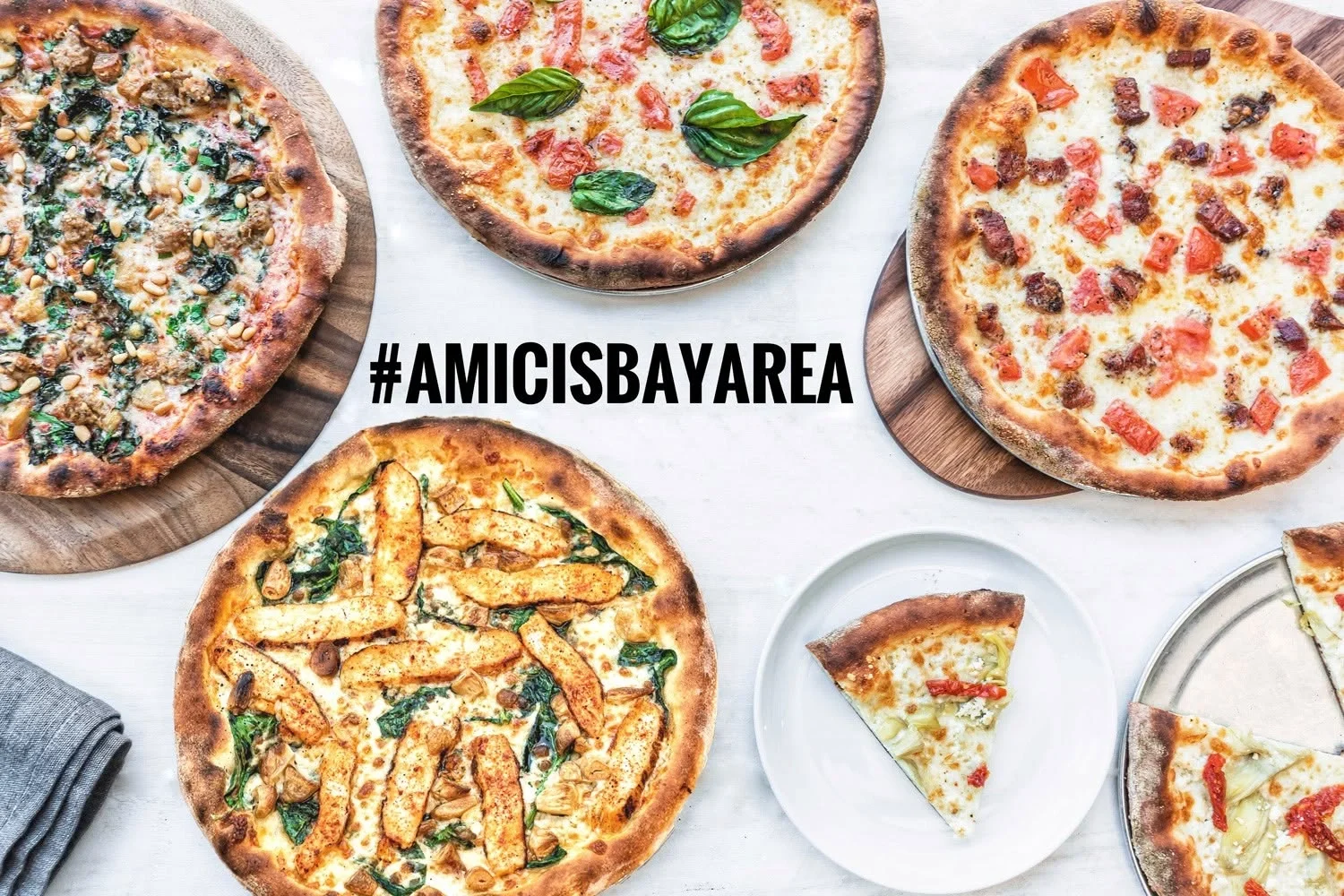 Overhead view of Amici's pizzas showcasing different crust styles and a variety of toppings.