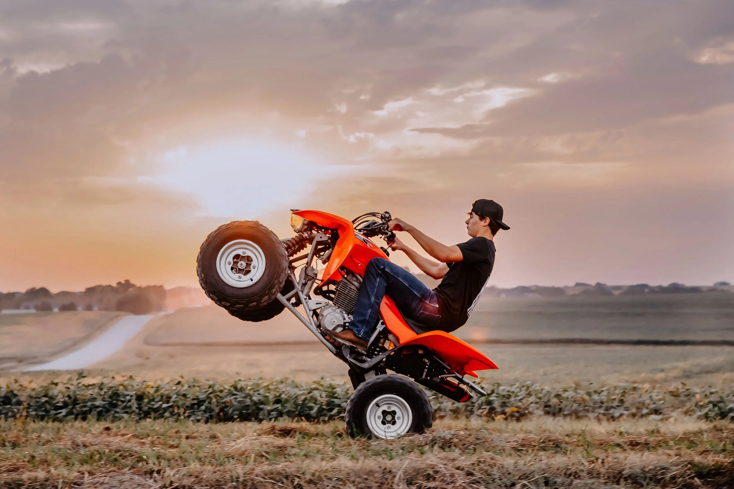 Omaha Senior Photographer during golden hour in fields 