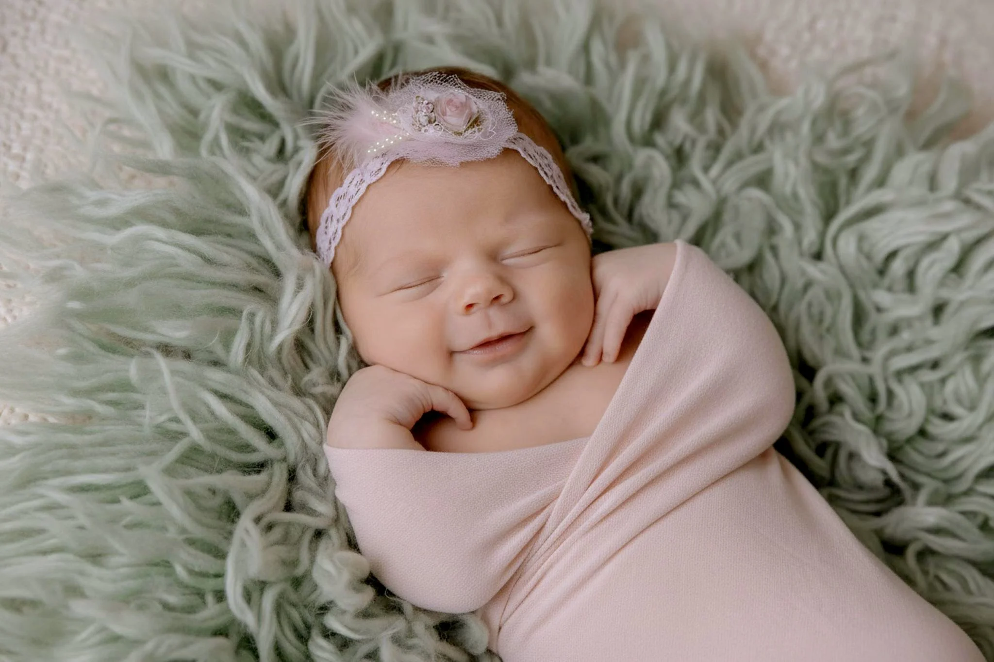 Omaha Newborn Photographer smiling little girl sleeping in pink 