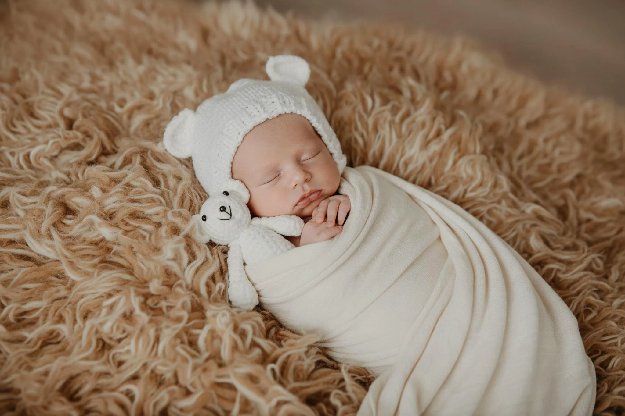 Omaha Newborn Photographer boy sleeping with teddy bear wrapped in white 