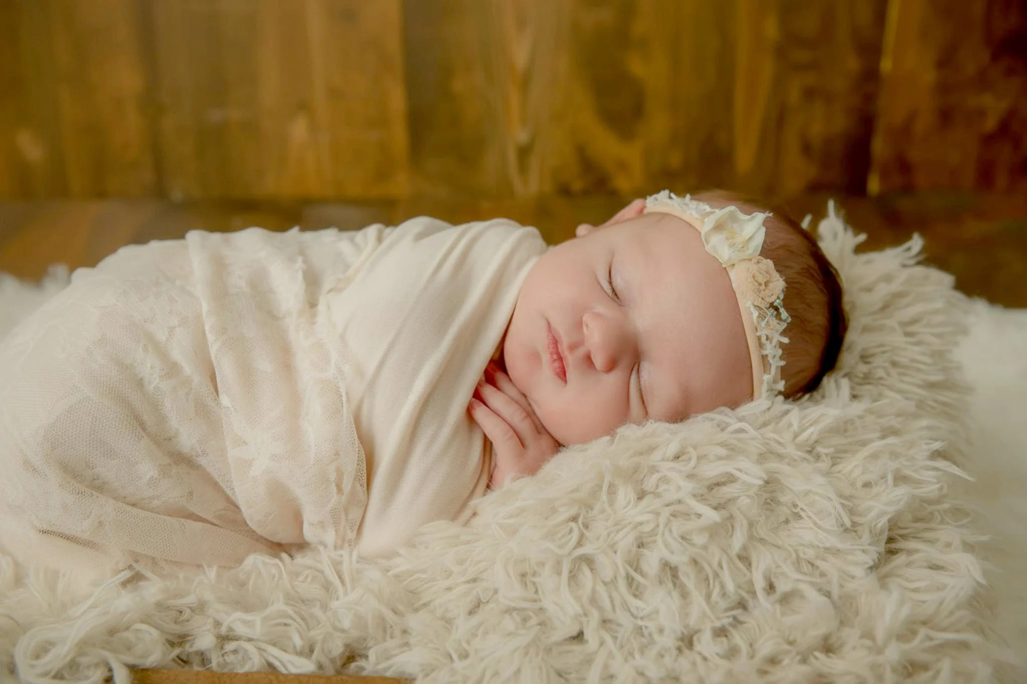 Omaha Newborn Photographer baby girl in all neutrals sleeping on bed 