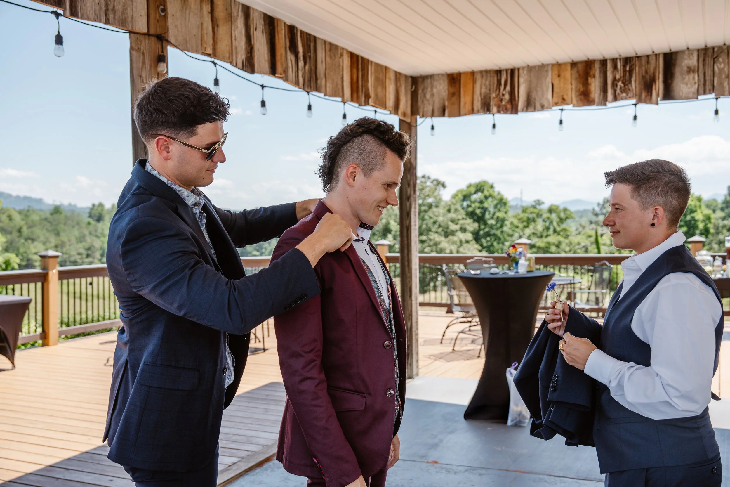 Groomsmen helping the groom get ready
