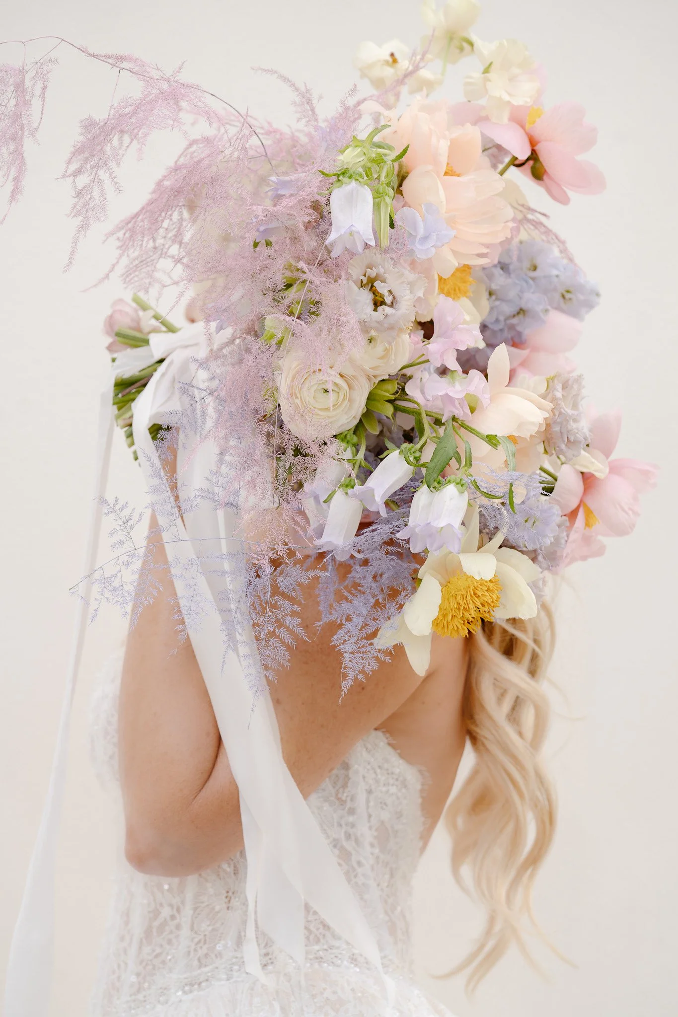 Perfectly crafted bouquet held over the shoulder.