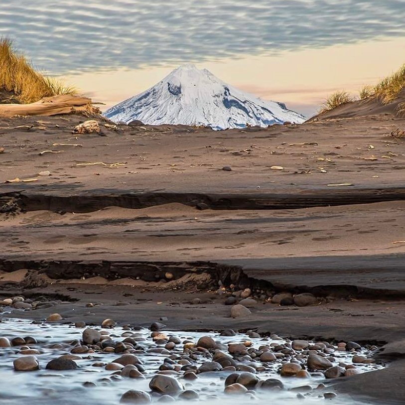 How beautiful is this shot from @photoflo_photography of the mountain to surf in Taranaki!? 📸 There&rsquo;s not many places where you could witness something as unique as this - your daily reminder to get out in your own backyard this winter 🏔🌊🤍 