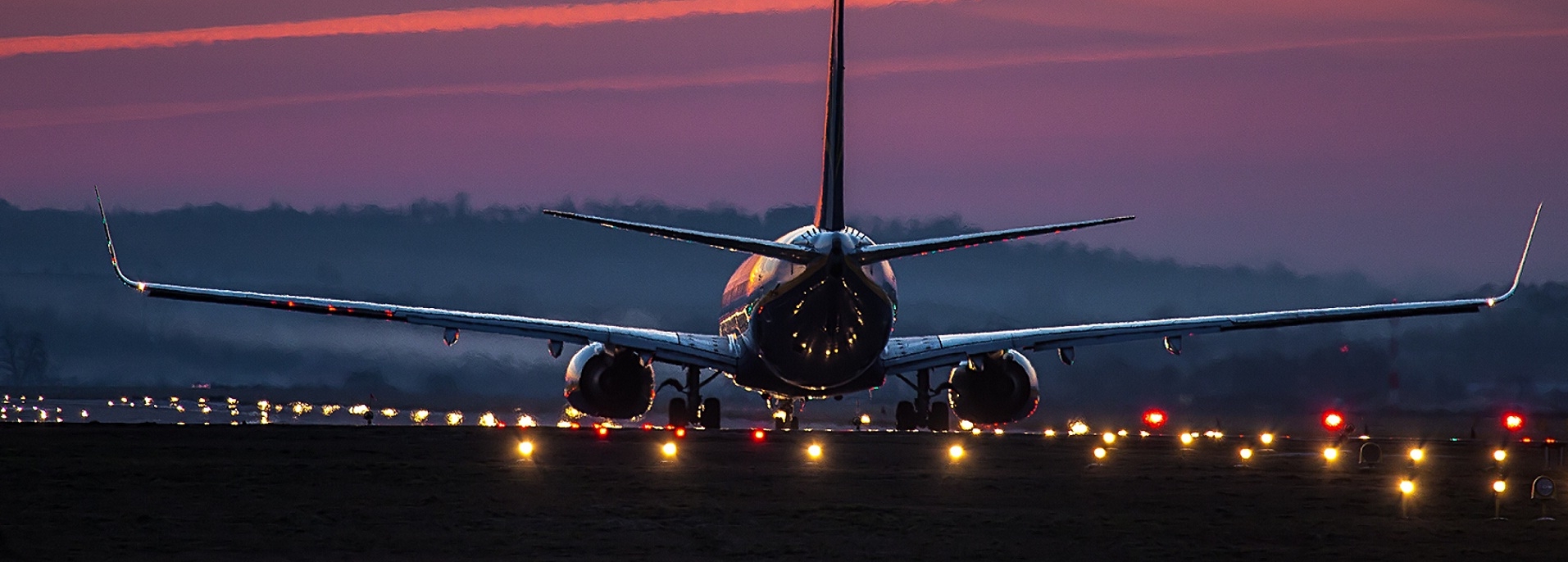 Airplane-landing-night-at-city.jpg