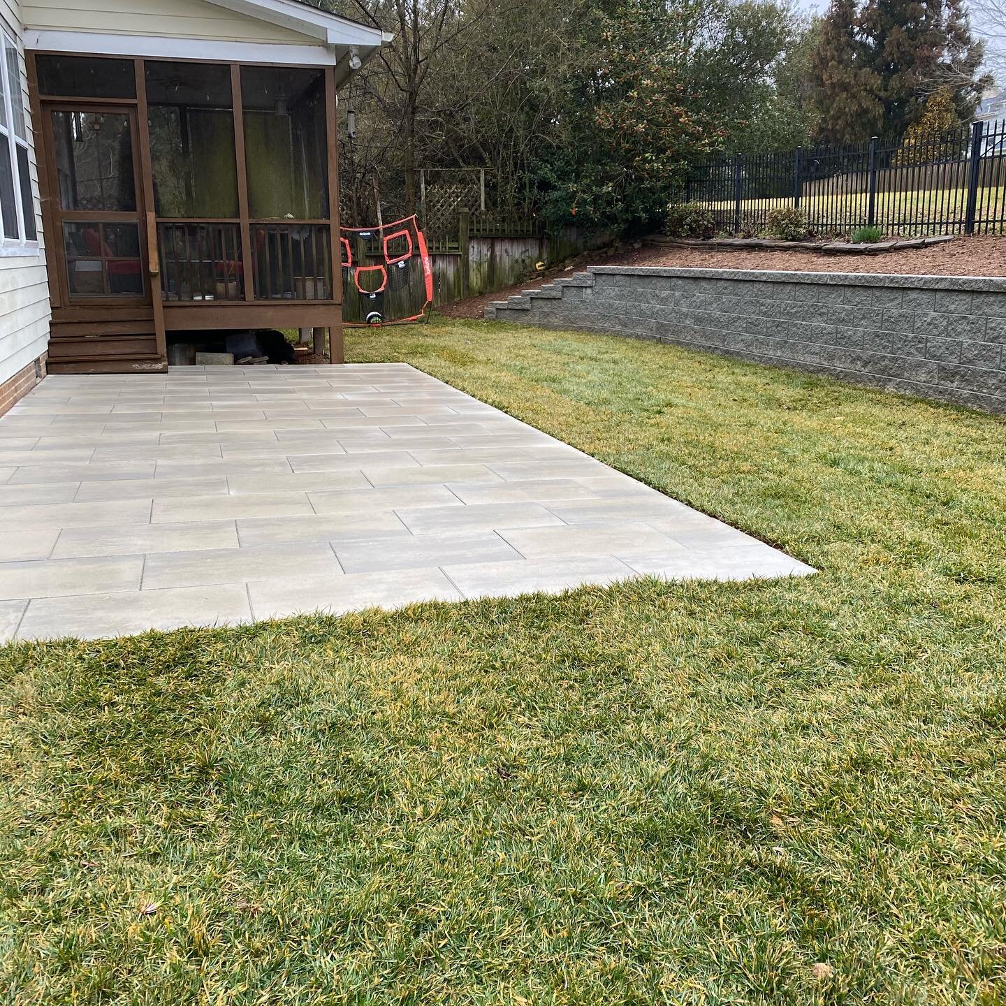 Thankfully we were able to get this project finished prior to all of the rain. The initial purpose of this project was to resolve some drainage issues in the backyard.  We ended up adding the retaining wall across the back of the property to help cre