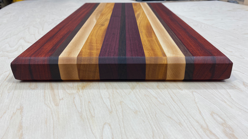 https://images.squarespace-cdn.com/content/v1/5a50cdd3b078698212f6e6af/1627221030998-697PJE4SS6DXLAIF4CEB/exotic+wood+cutting+board.png?format=500w
