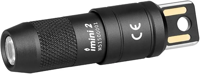 Black OLIGHT IMINI 2 rechargeable keychain flashlight showing the magnetic cap and integrated USB charging plug.