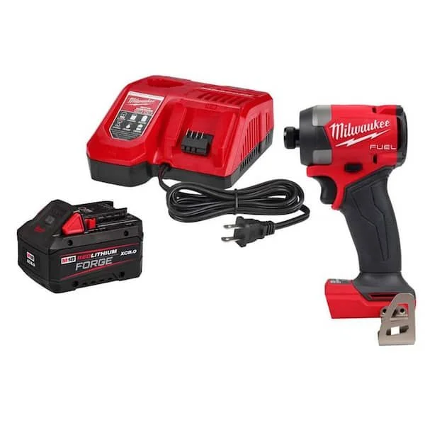 Milwaukee M18 REDLITHIUM FORGE XC8.0 Battery and Rapid Charger alongside an M18 1/4 inch Impact Driver on a workshop table