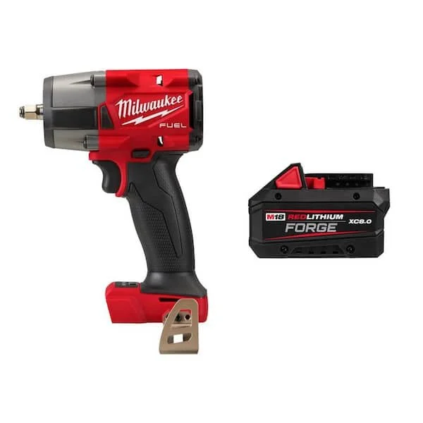 Milwaukee M18 FUEL 3/8 inch Mid Torque Impact Wrench with friction ring and M18 REDLITHIUM battery pack on a garage floor