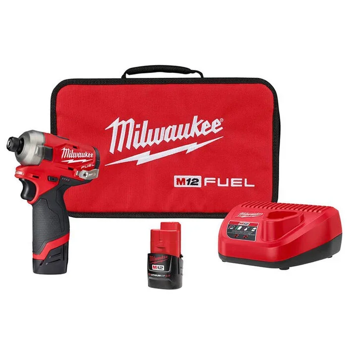 Selection of Milwaukee M12 cordless power tools including impact drivers and drills with the signature red and black professional finish.