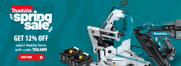 A selection of professional Makita cordless power tools and batteries displayed on a clean workshop surface.