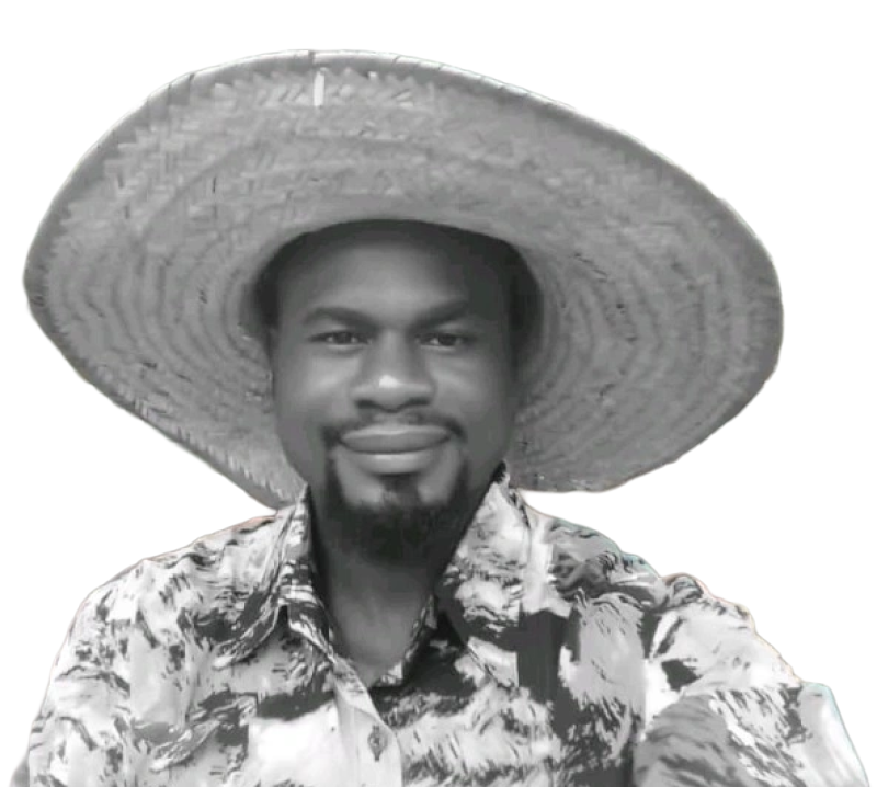 A man wearing a large straw hat and a patterned shirt, smiling, in a black and white photo.