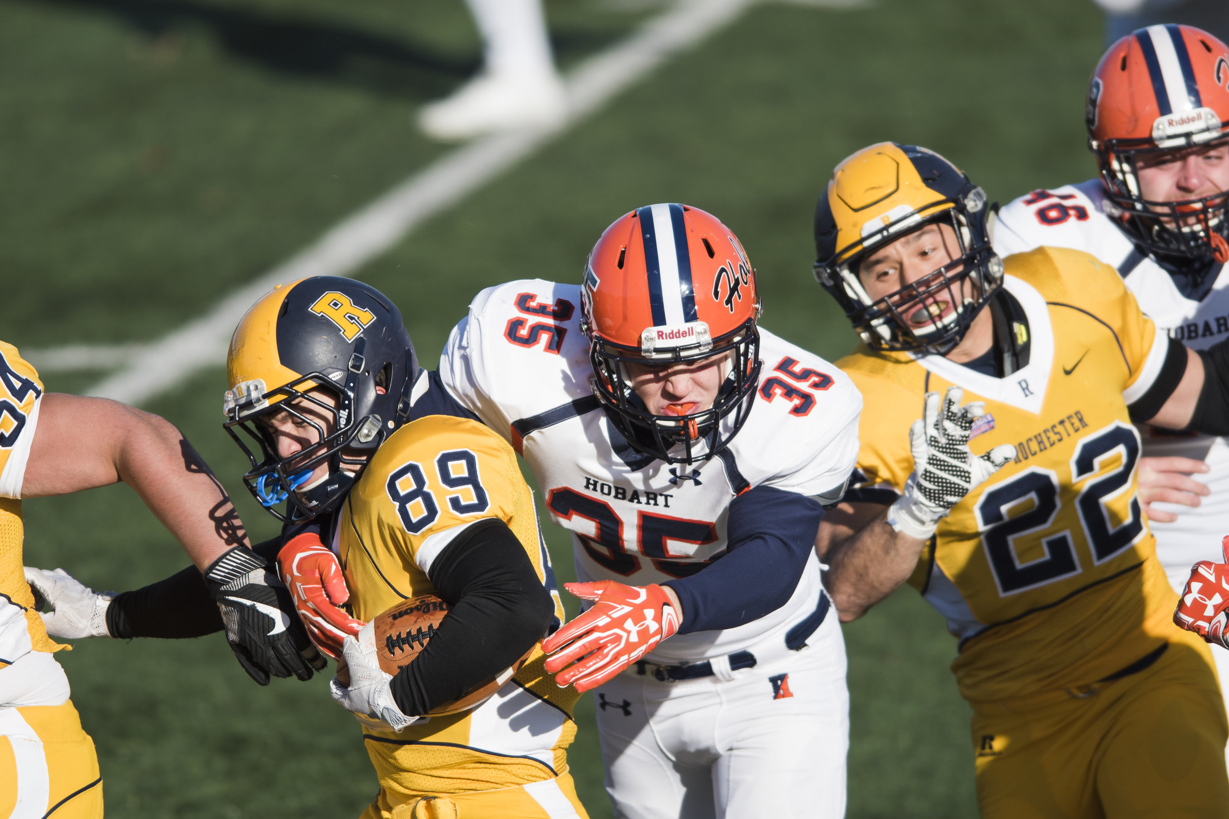  Chris Penman (89), wide receiver for The University of Rochester Yellowjackets, runs the downfield while pursued by outside linebacker Collin Urie (35), the outside linebacker for the Hobart and William Smith (HWS) Statesmen, and HWS cornerback Bren