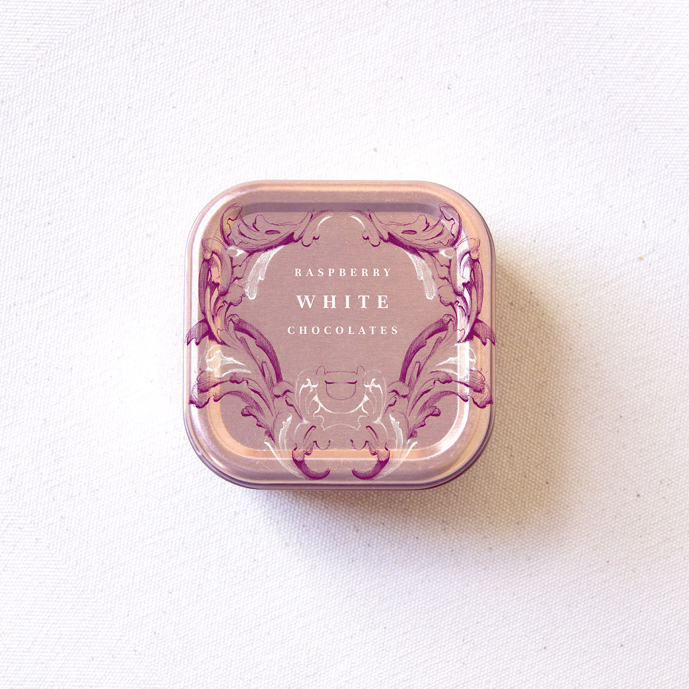 Rococo-inspired raspberry white chocolate metallic package illustration by Laura Dreyer.
