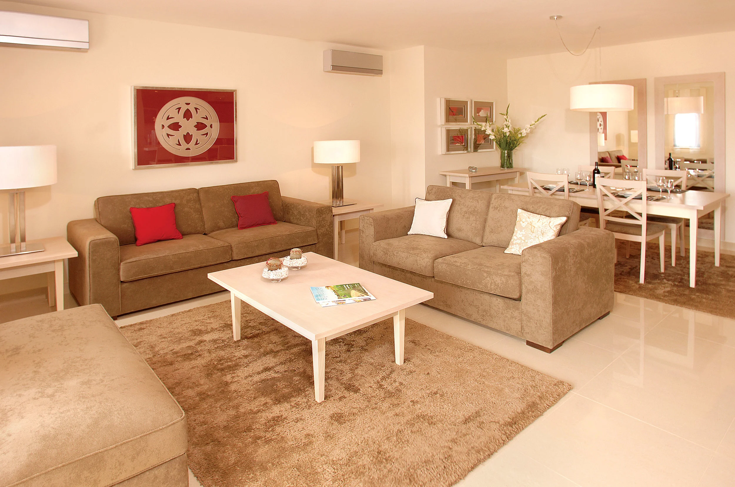 TWO BEDROOM APARTMENT The two bedroom apartments are all located on the ground floor with approximately 108sqm. The kitchen is fully equipped with washing machine, dishwasher, fridge/freezer, microwave, oven, electric hob, kettle, toaster, blender and kitchenware. The apartment also has a spacious lounge, dining area, two bedrooms and two bathrooms. There are patio doors to a terrace from the living room which is supplied with outdoor furniture. The apartments are served by communal swimming pools.