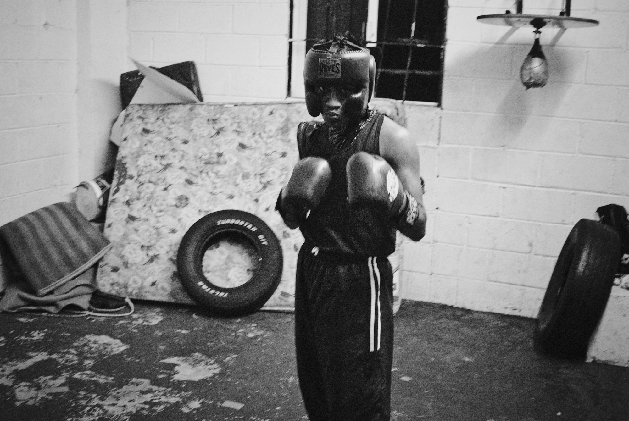  Young amateur boxer gives the stance in coach Cervantes’s boxing gym. 