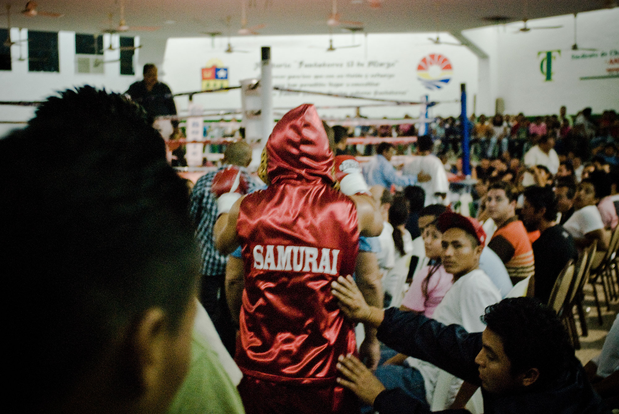 Boxer “Samurai” is being cheered during his walk to the ring.