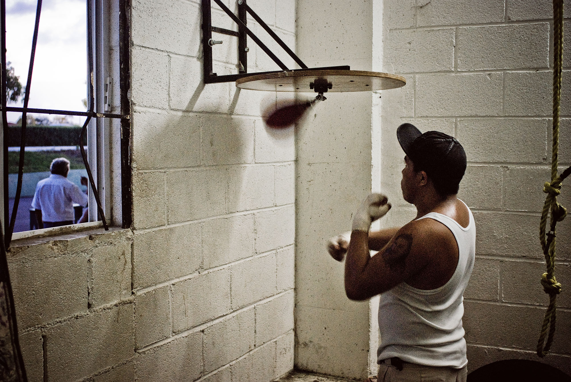  Coach Cervantes walking away as an apprentice continues on the speed bag. 